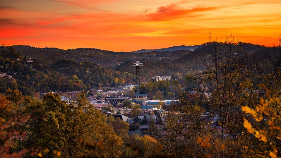 Stunning expansive aerial drone perspective of Knoxville Tennessee surrounded by lush green mountain landscapes.