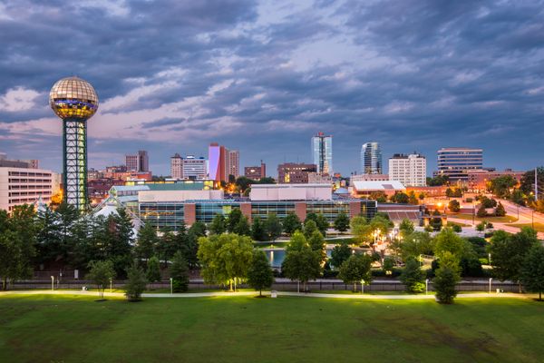 Expansive daytime view of the Knoxville Tennessee skyline nestled against the majestic Great Smoky Mountains.